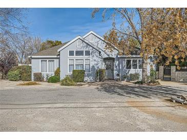 Single-story home with gray exterior, landscaping, and gated entrance at 7000 W Rome Blvd, Las Vegas, NV 89131