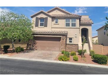 Charming two-story home with a two-car garage, stone accents, and a well-manicured front yard at 7914 Torreys Peak St, Las Vegas, NV 89166