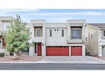 Two-story modern home with red doors and two-car garage at 9753 Russian Hill St, Las Vegas, NV 89141