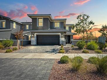 Two-story home with gray exterior, a two-car garage, and landscaping at 800 Cadence View Way, Henderson, NV 89011