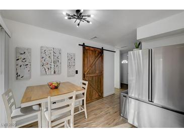 Bright kitchen features stainless steel appliances and a dining area at 155 E Van Wagenen St, Henderson, NV 89015