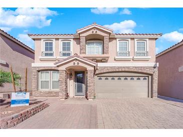 Two-story house with stone accents and a three-car garage at 6360 Stag Hollow Ct, Las Vegas, NV 89139