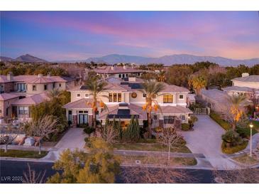 Luxury home with solar panels, expansive driveway, and mountain views at 10308 Rocky Mesa Ct, Las Vegas, NV 89144