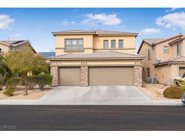 Two-story house with a three-car garage and landscaped front yard at 1932 Barrow Glen Ct, North Las Vegas, NV 89084