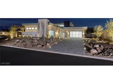 Luxury home with modern architecture, landscaped grounds, and a large driveway at 37 Reflection Shores Ln, Henderson, NV 89011