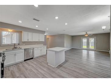 Updated kitchen features white cabinets, stainless steel appliances, and an island at 3834 S Sandhill Rd, Las Vegas, NV 89121