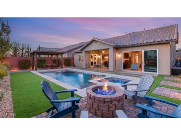 Stunning backyard with a sparkling pool, fire pit, and seating area at 7563 Saguaro Cactus Ave, Las Vegas, NV 89178