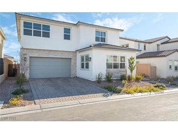 Two-story house with gray garage door and landscaping at 8990 Rolling Pietra St, Las Vegas, NV 89166