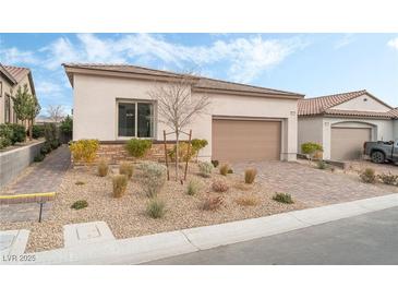 Single-story home with attached garage and landscaped front yard at 10262 Super Jovian St, Las Vegas, NV 89143