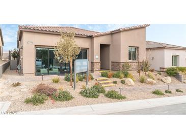 Single-story home with landscaped front yard, neutral color palette, and modern design at 10270 Super Jovian St, Las Vegas, NV 89143