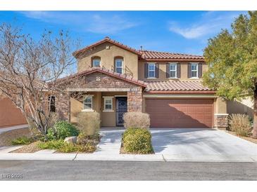 Two-story house with brown accents and landscaping at 10597 Painted Bridge St, Las Vegas, NV 89179