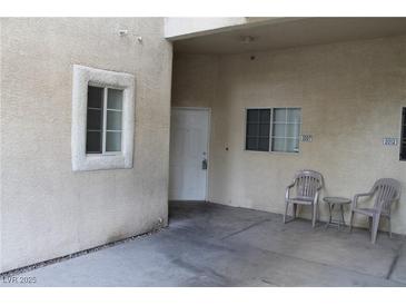 Exterior view of condo building showing private entrance and patio area with chairs at 2007 Cutlass Dr # 0, Henderson, NV 89014