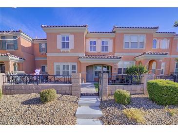 Two-story townhome with front patio and landscaped yard at 2120 Waterlily View St, Henderson, NV 89044