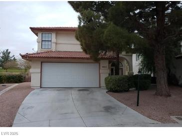 Two-story house with attached garage and landscaped yard at 4801 Fiesta Lakes St, Las Vegas, NV 89130