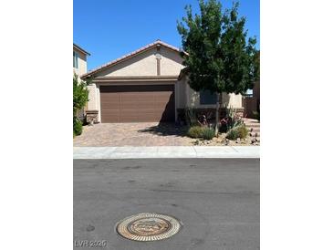 Single-story home with brown garage door and well-manicured landscaping at 6306 Orions Belt Peak St, North Las Vegas, NV 89031