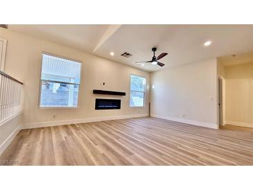 Bright living room featuring a fireplace and hardwood floors at 10173 Grants Arbor Rd, Las Vegas, NV 89183