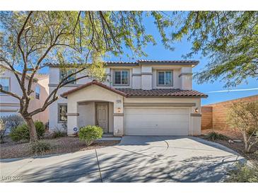 Two-story house with a large garage and mature trees in the front yard at 11276 Accademia Ct, Las Vegas, NV 89141