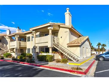 Attractive exterior of a two-story condo with stairs and landscaping at 1205 Sulphur Springs Ln # 101, Las Vegas, NV 89128