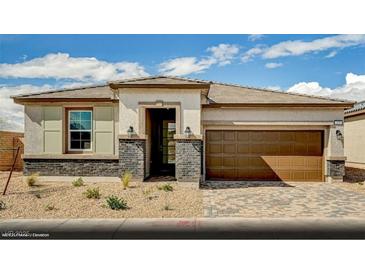 Charming single-story home featuring a two-car garage, neutral stucco, and stone accents for added curb appeal at 129 Castanet Ln # Lot 190, Henderson, NV 89015