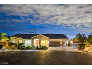 Single-story home with a two-car garage, landscaping, and a neutral color palette at 156 Ozuna Ct, Las Vegas, NV 89183