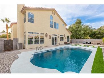 Inviting backyard oasis featuring a sparkling pool and grassy area at 1713 Sequoia Dr, Henderson, NV 89014