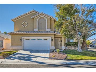 Two-story house with a landscaped yard and attached two-car garage at 2525 Huber Heights Dr, Las Vegas, NV 89128