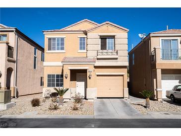 Two-story house with beige exterior, attached garage, and landscaping at 6074 Lazarro Ct, Las Vegas, NV 89139