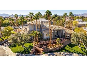 Beautiful home with desert landscaping, tile roof and palm trees at 7880 Dana Point Ct, Las Vegas, NV 89117