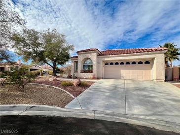 Single-story house with a two-car garage and nicely landscaped front yard at 8116 Sedona Sunset Dr, Las Vegas, NV 89128