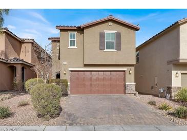 Two-story house with brown garage door and landscaped yard at 9202 Valley Betica Ave, Las Vegas, NV 89148