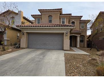 Two-story house with attached garage and Spanish-style architecture at 10046 Dancing Lasso Ct, Las Vegas, NV 89178