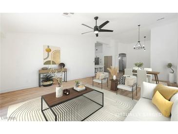 Virtually staged living room features a neutral color palette, modern furniture, and hardwood floors at 10229 Birch Bluff Ln, Las Vegas, NV 89145