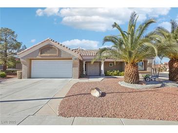 Single-story home with a two-car garage and desert landscaping at 2413 Hidden Glen Ct, Las Vegas, NV 89134