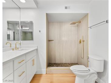 Updated bathroom with double vanity, walk-in shower, and gold fixtures at 2620 San Martin Ct, Las Vegas, NV 89121