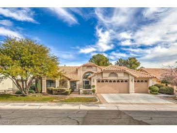 Single-story home with landscaped yard and two-car garage at 3128 Pelican Beach Dr, Las Vegas, NV 89117