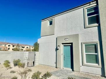 Modern two-story home with teal door and landscaping at 340 Banished Ave # 2, North Las Vegas, NV 89031