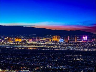 Stunning night-time panoramic view of the city skyline against a colorful twilight sky and mountain backdrop at 371 Tranquil Peak Ct, Henderson, NV 89012