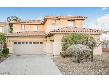 Two-story house with beige exterior, two-car garage, and landscaping at 3748 Honey Crest Dr, Las Vegas, NV 89135