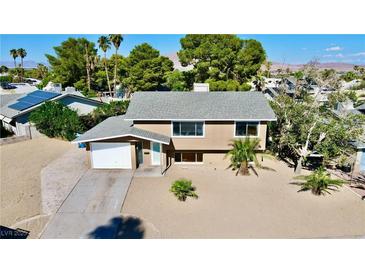 Tan two-story house with a landscaped yard and solar panels at 3950 Ventura Way, Las Vegas, NV 89121