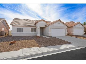 Single-story house with a two-car garage and desert landscaping at 4313 Beach Cliff Ave, North Las Vegas, NV 89031