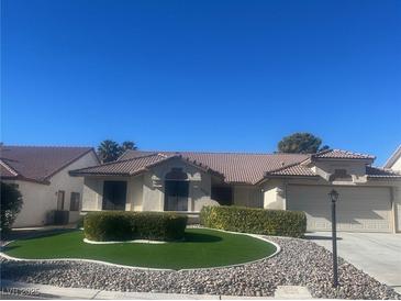 Single-story home with landscaped yard and two-car garage at 5728 Palma Del Sol Way, Las Vegas, NV 89130