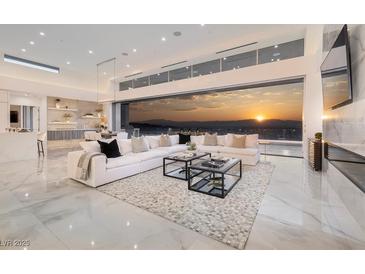 Bright, spacious living room featuring marble floors, modern furniture, and a stunning sunset view at 665 Overlook Rim Dr, Henderson, NV 89012