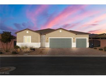 Single-story house with three-car garage and desert landscaping at 74 Wildcat Ave, Pahrump, NV 89060