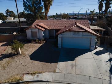 Single-story house with tile roof, attached garage, and a small front yard at 8072 Hackberry Dr, Las Vegas, NV 89123