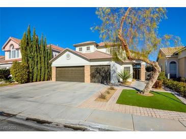 Two-story house with a three-car garage and landscaped front yard at 8466 Lambert Dr, Las Vegas, NV 89147