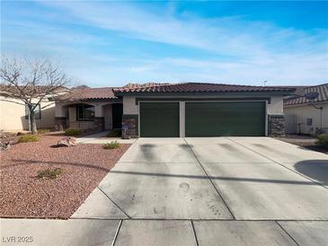 Single-story home with a two-car garage and well-manicured landscaping at 866 Austin Peak Ct, Las Vegas, NV 89110