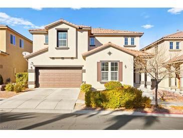 Two-story house with a tan exterior, brown garage door, and landscaping at 9124 Ironstone Ave, Las Vegas, NV 89143