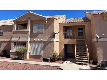 Tan two-story building with stairs and satellite dishes at 1830 N Pecos Rd # 237, Las Vegas, NV 89115