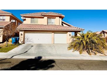 Two-story house with a two-car garage and mature landscaping at 9356 Sparkling Waters Ave, Las Vegas, NV 89129