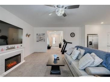 Spacious living room features a cozy fireplace and ample natural light at 10467 Joaquin Fire St, Las Vegas, NV 89141